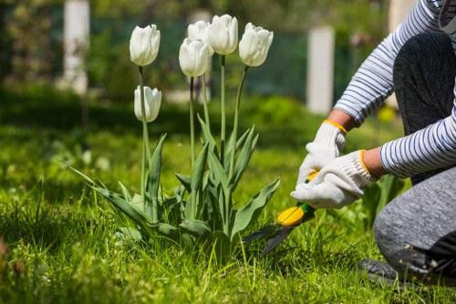 Gardener assessing a small urban garden in Shoreditch, close-up of tools and soil